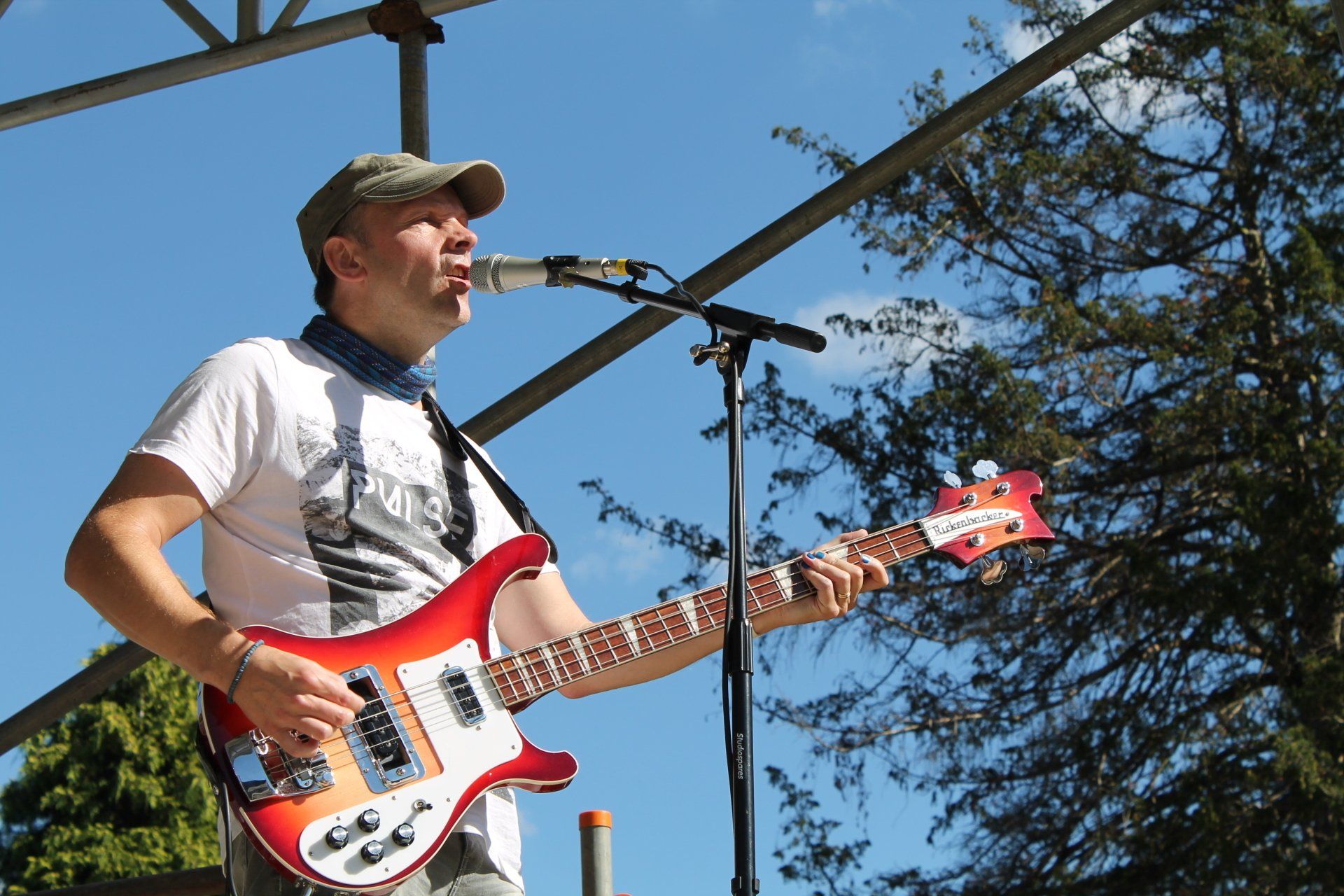 musician performing with bass guitar at festival