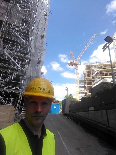 man PAT Testing on building site