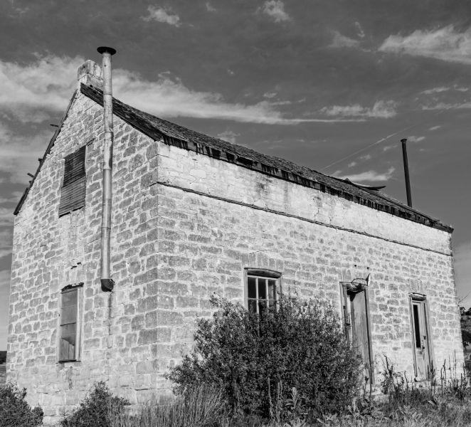 a black and white photo of an old stone building