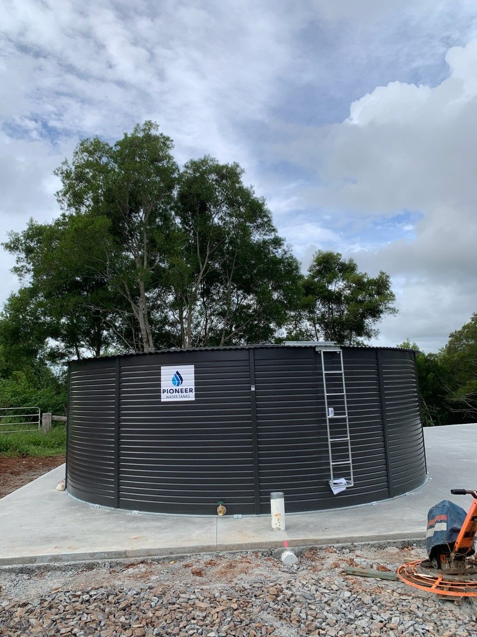 A Large Black Water Tank With a Ladder Attached to It — Elite Water In Koonorigan, NSW