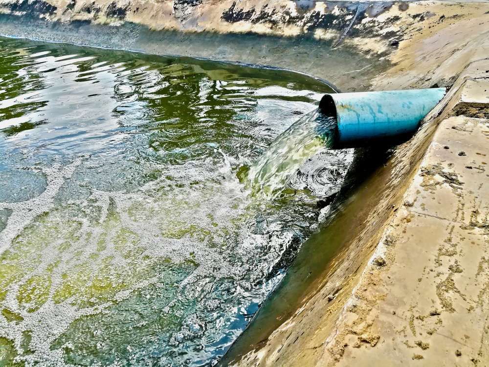 A Pipe is Pouring Water Into a Body of Water — Elite Water In Casino, NSW
