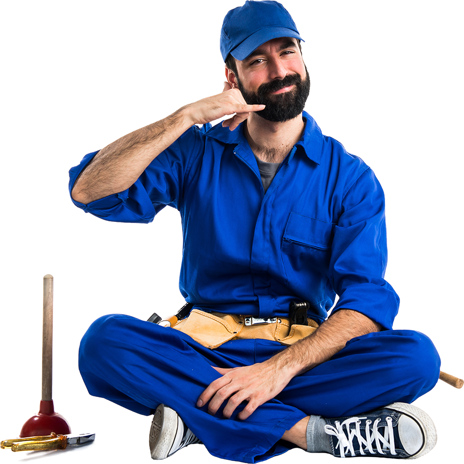 Plumber in blue overalls gesturing a phone call, sitting with tools.