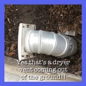A dryer vent is coming out of the ground
