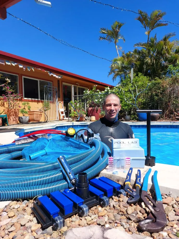 Man in Wetsuit by Pool With Pool Cleaning Equipment — Ballina Leak Detection & Swimming Pool Repairs in Ballina, NSW