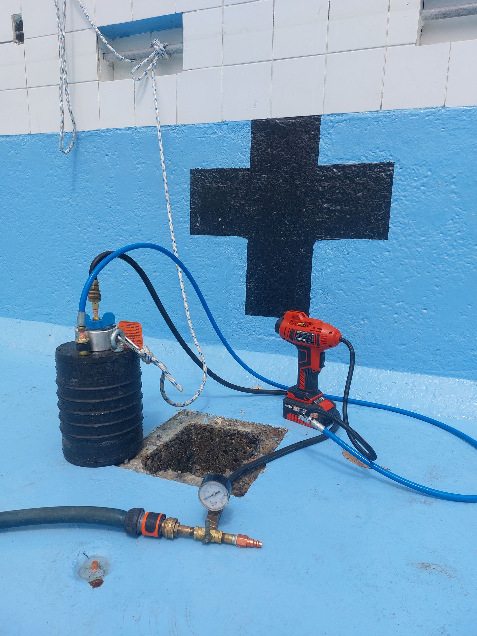 Blue Pool Cover on a Kidney-shaped Pool With Brick Surround — Ballina Leak Detection & Swimming Pool Repairs in Ballina, NSW