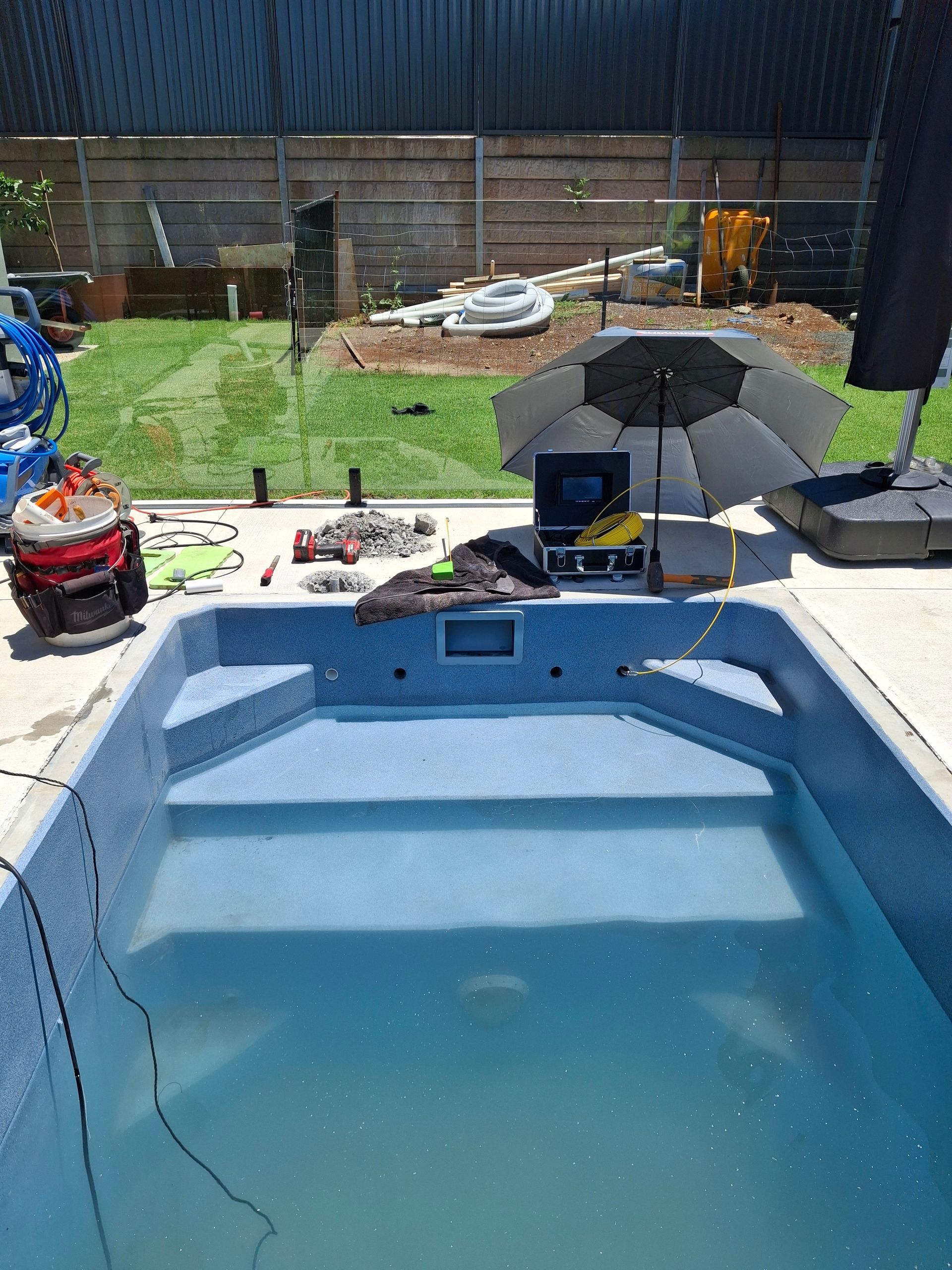 A Person Underwater in A Pool, Holding a Breath-Hold Guide — Ballina Leak Detection & Swimming Pool Repairs in Ballina, NSW