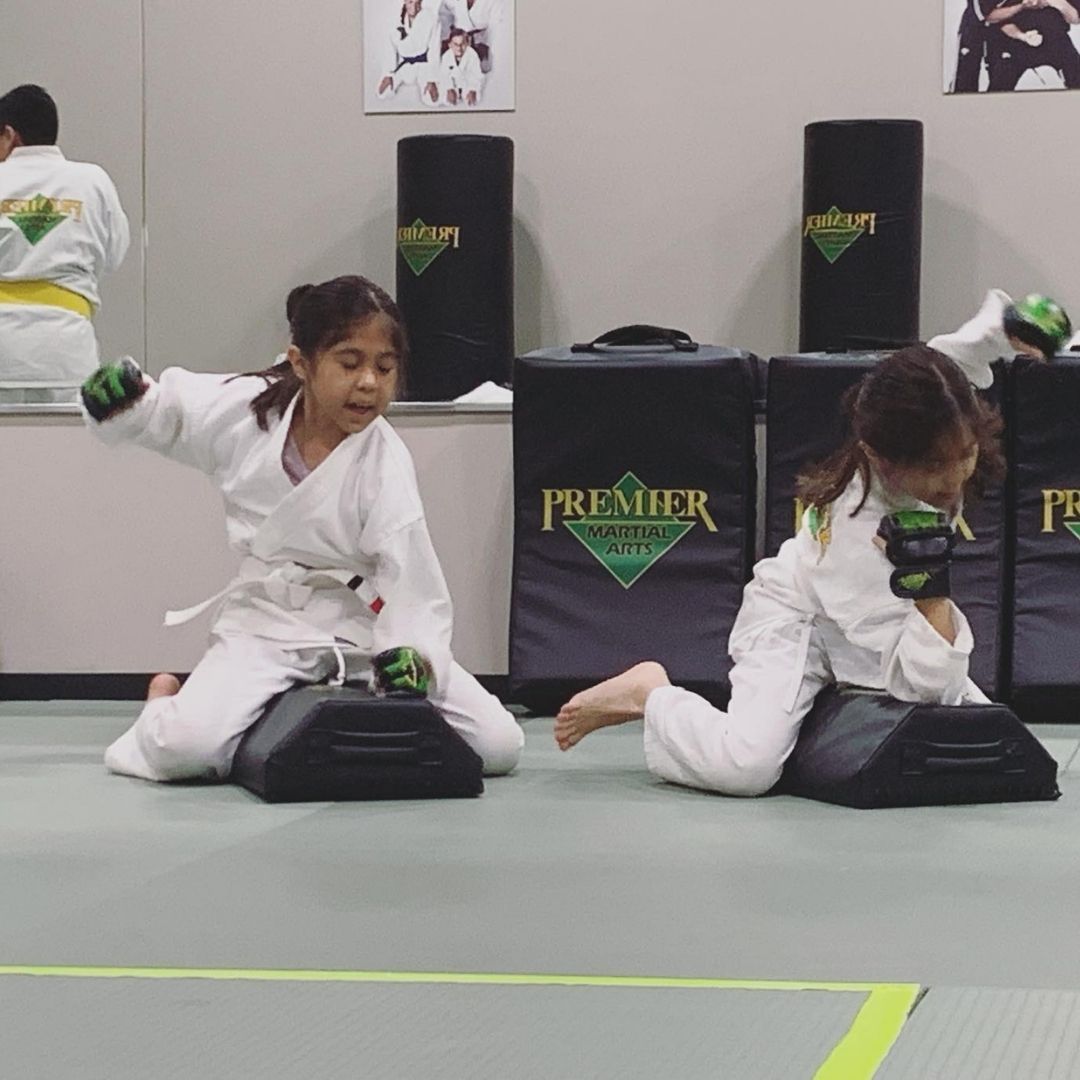 A boy and a girl are practicing taekwondo together.
