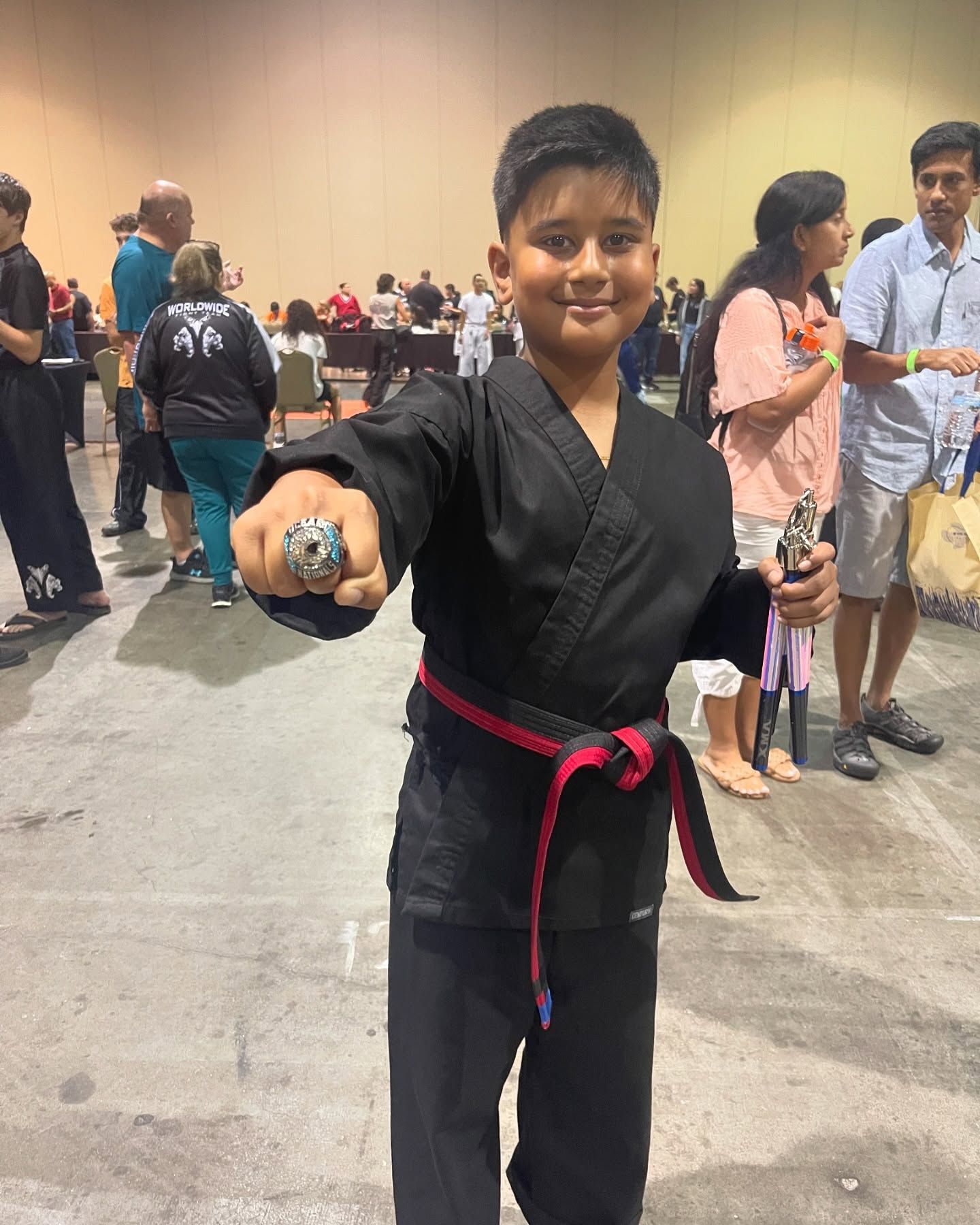 A person is holding a sparkler in their hand in the dark.