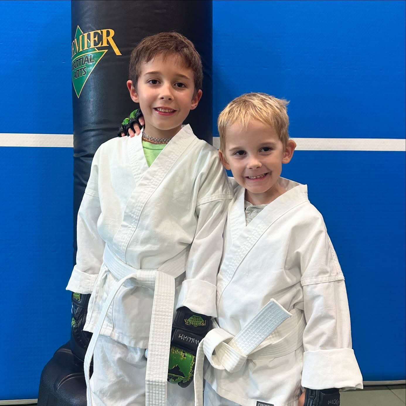 A person is holding a sparkler in their hand in the dark.