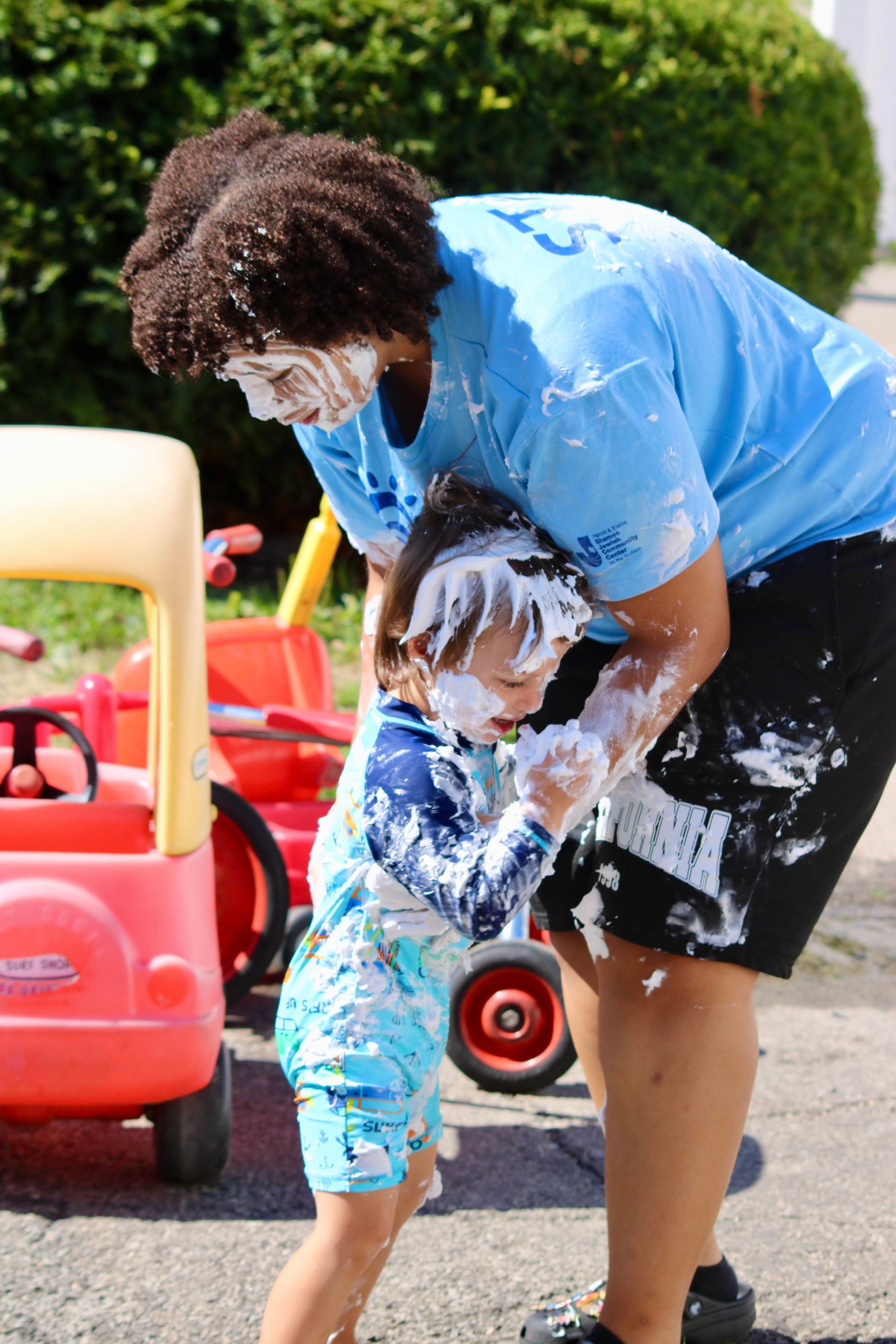 a counselor with a boy playing with soap bubbles