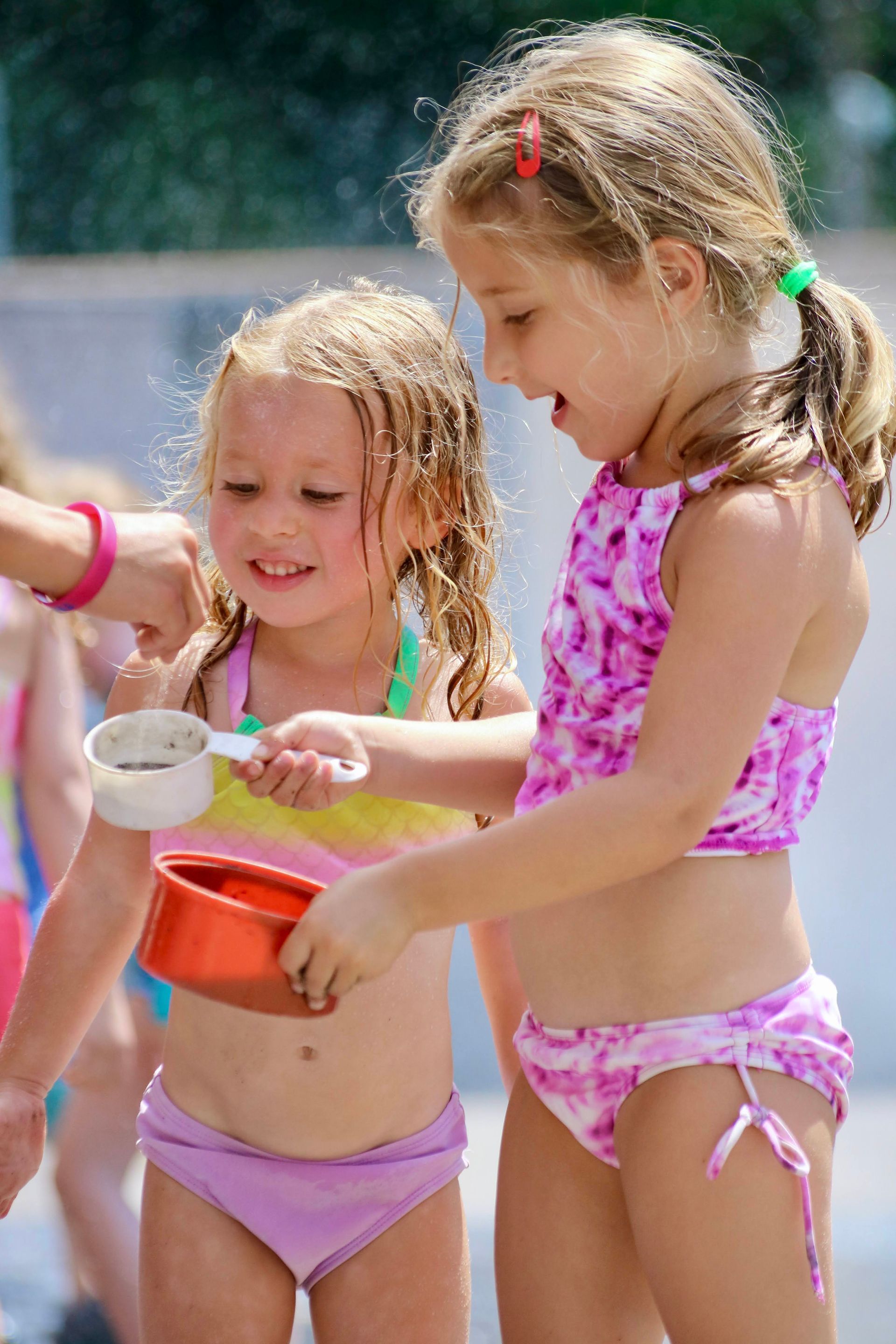 two girls playing with sand