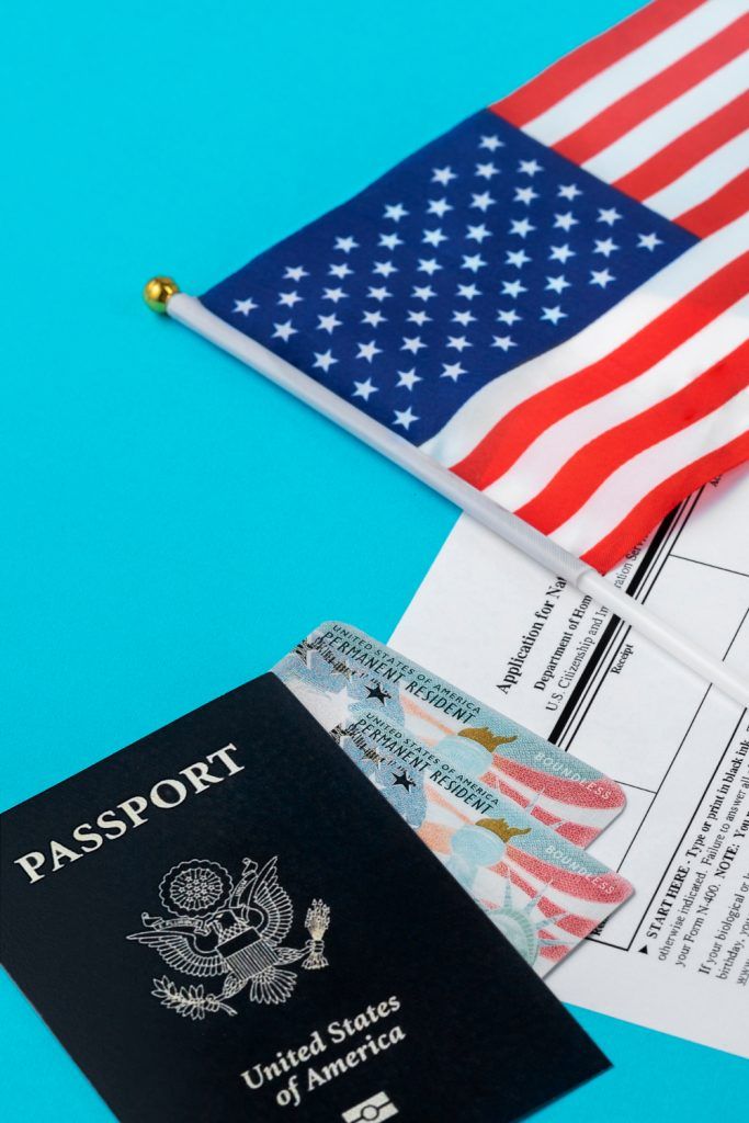 U.S. passport, visa cards, American flag, and application on blue background.