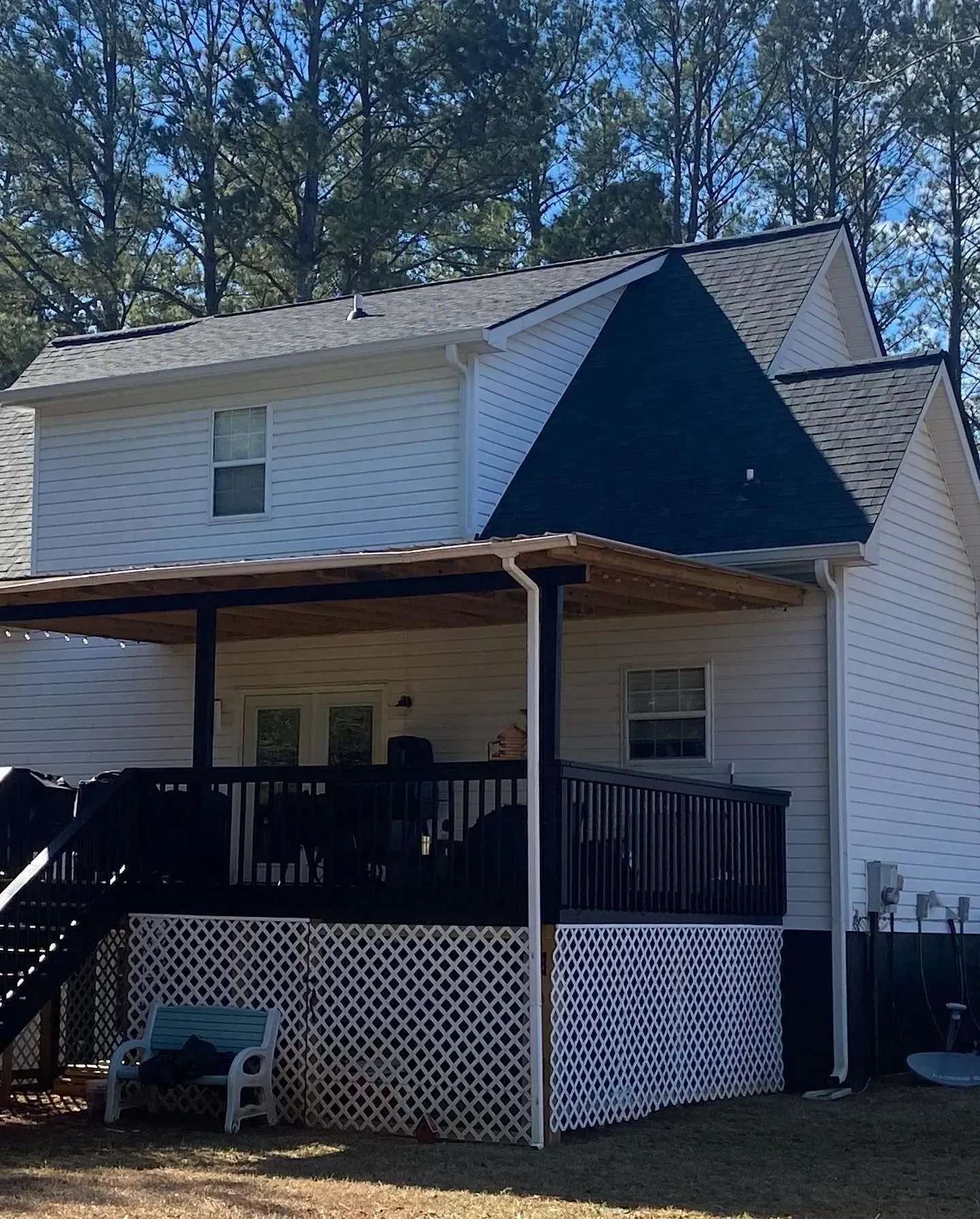 A white house with a black triangle on the roof