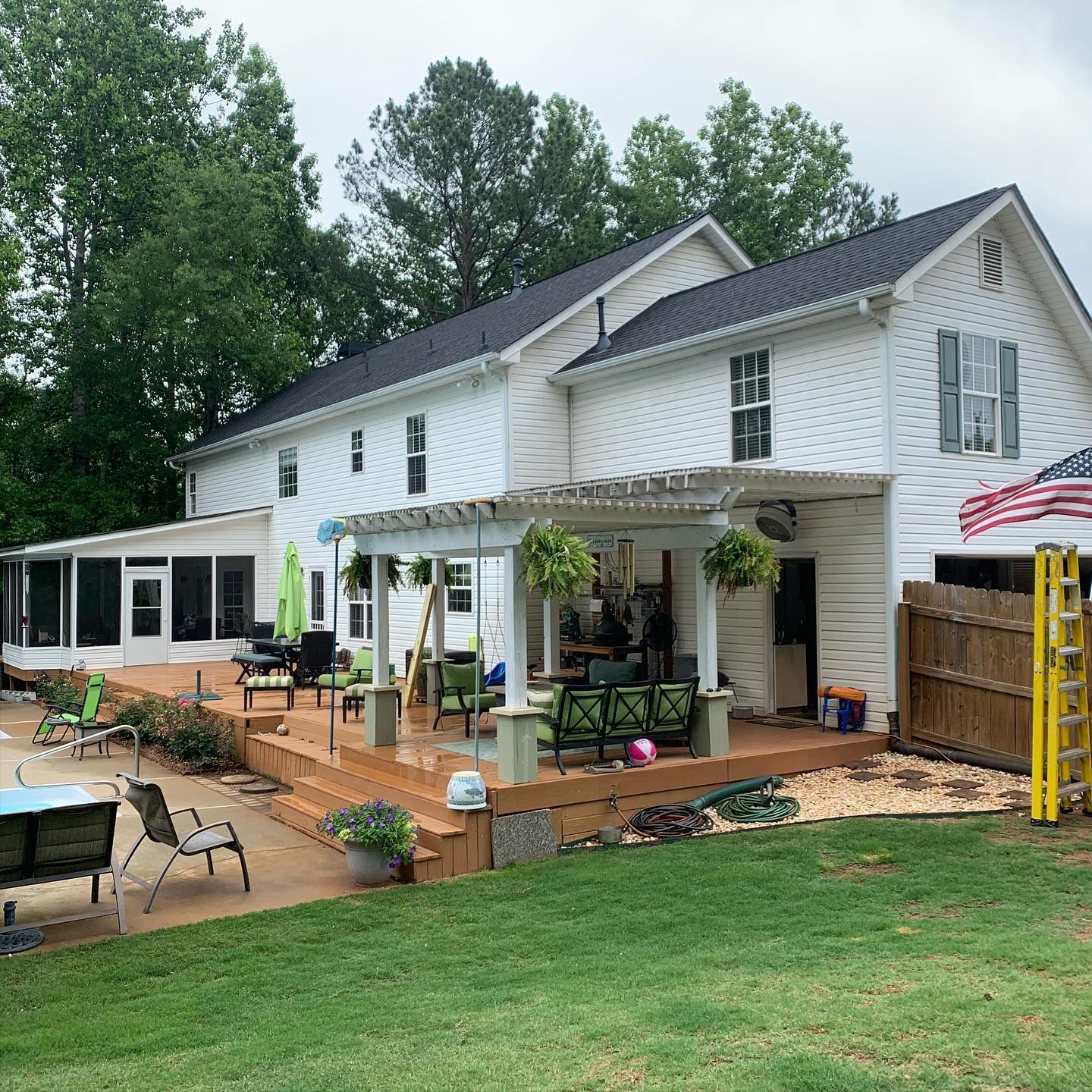 A large white house with a large lawn in front of it.