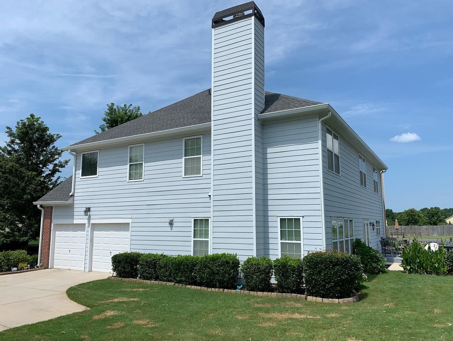 A large white house with a chimney on top of it
