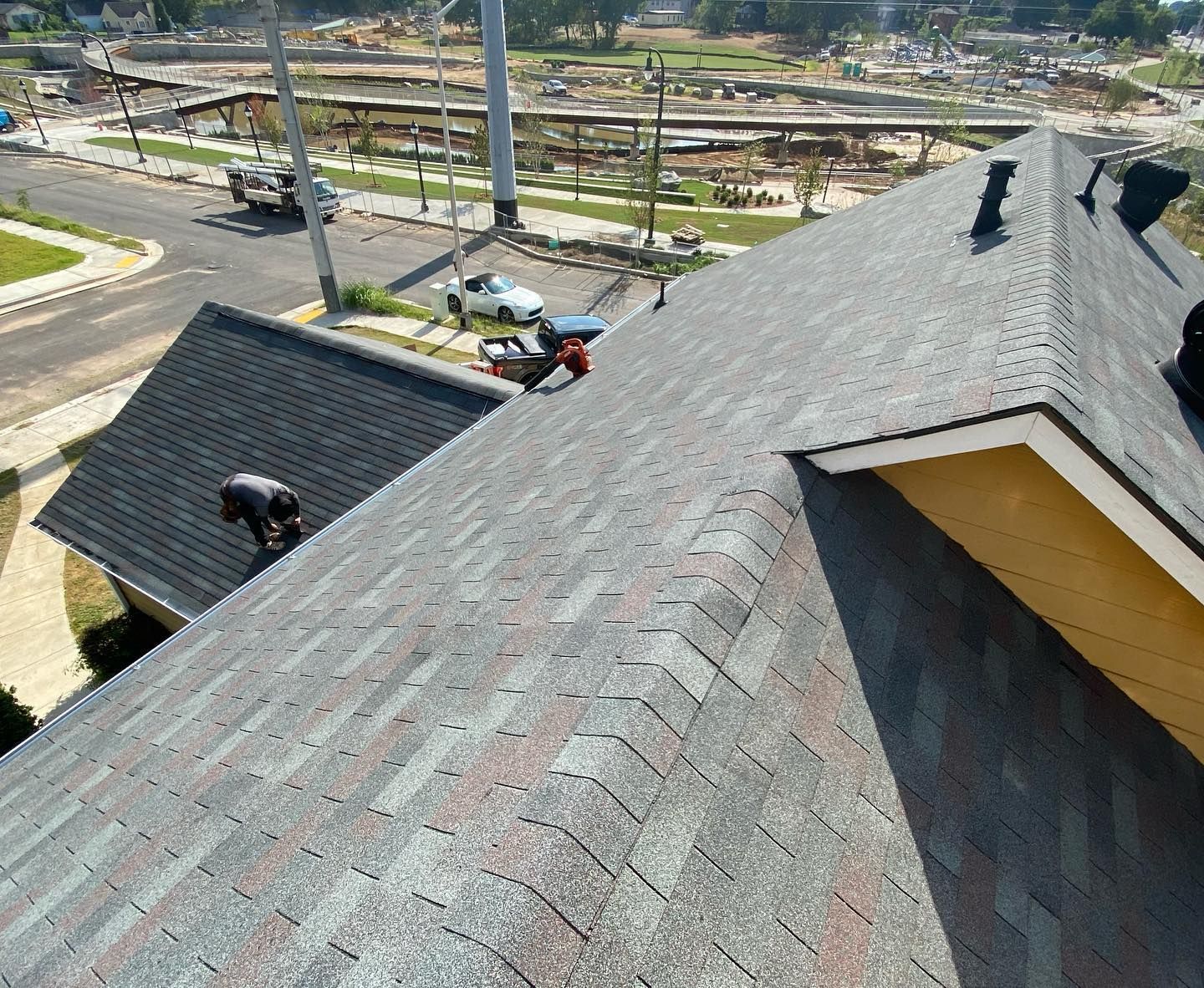 A man is working on the roof of a house