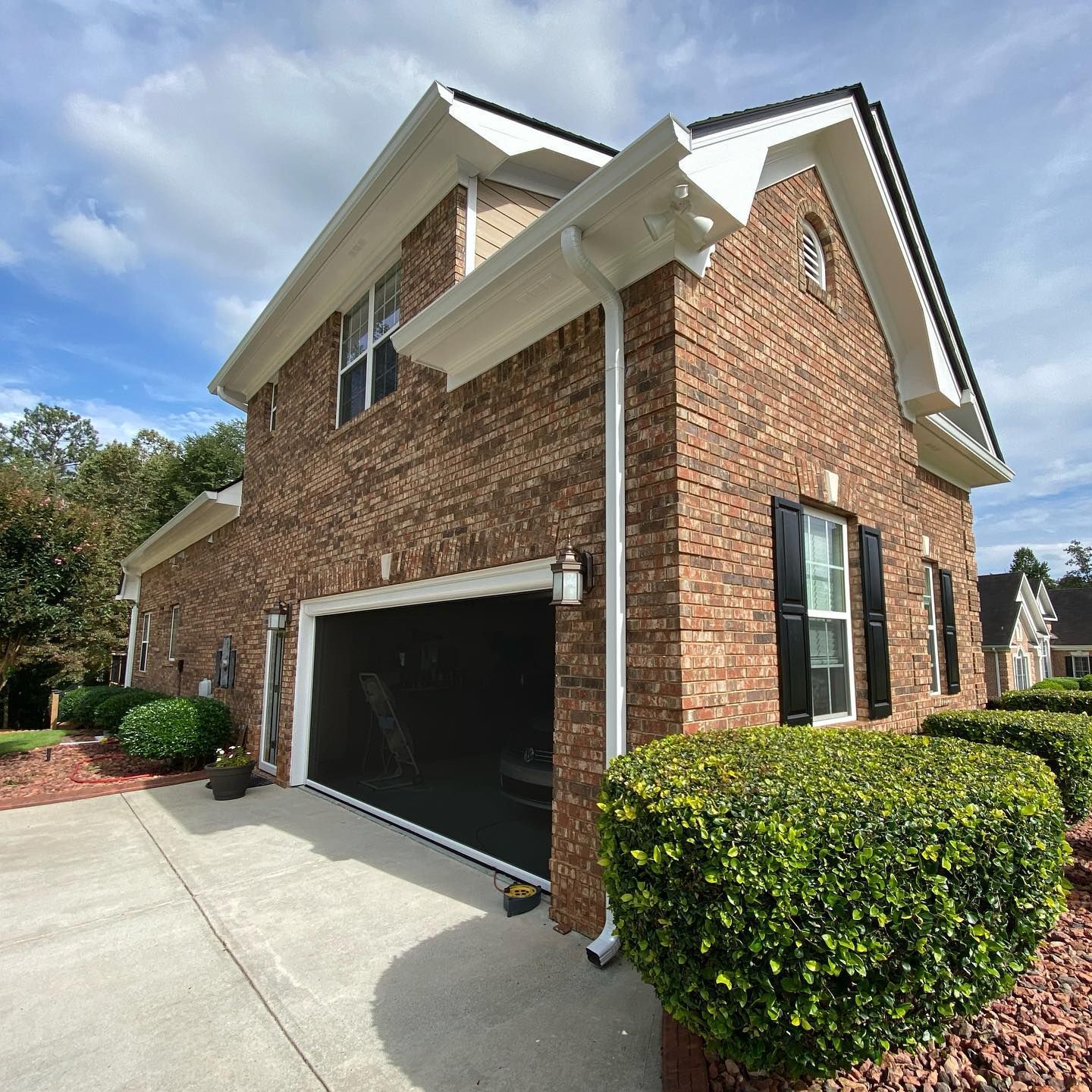A large brick house with a black garage door
