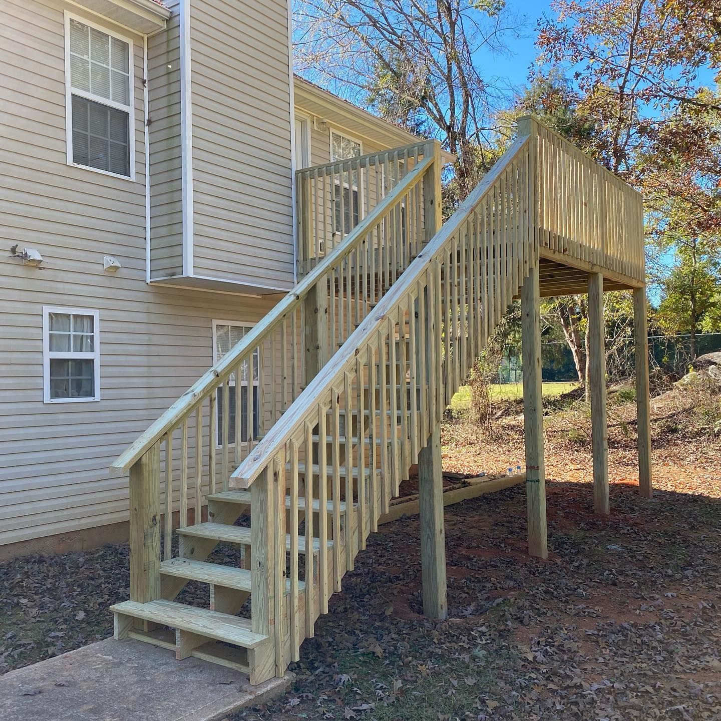A wooden deck with stairs leading up to it