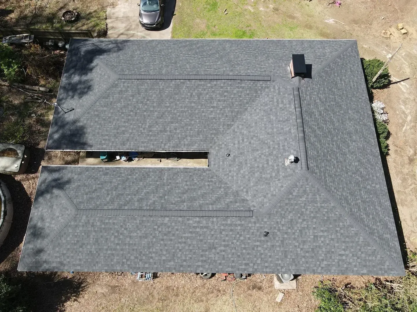 An aerial view of a house with a new roof.