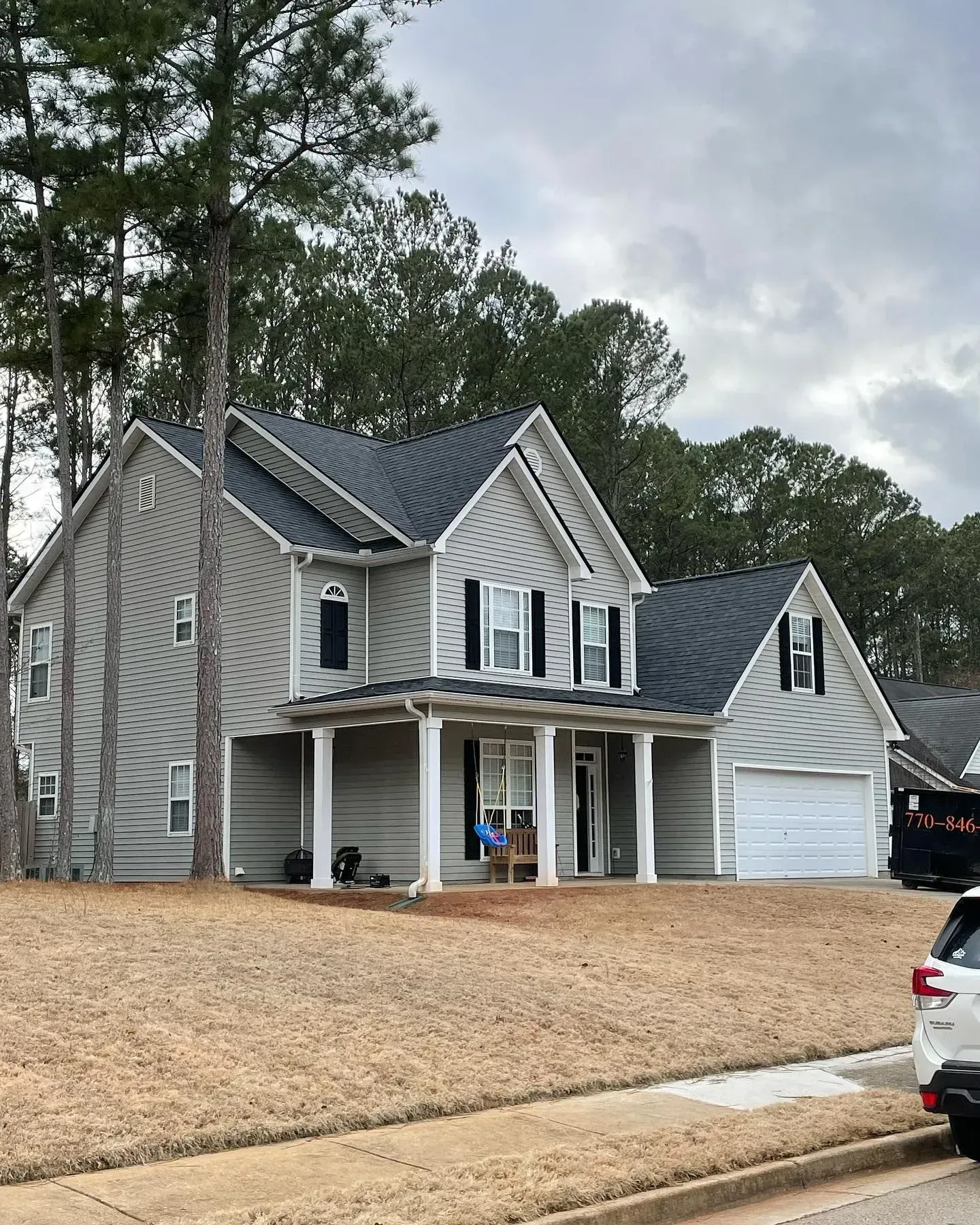 A large house with a car parked in front of it.