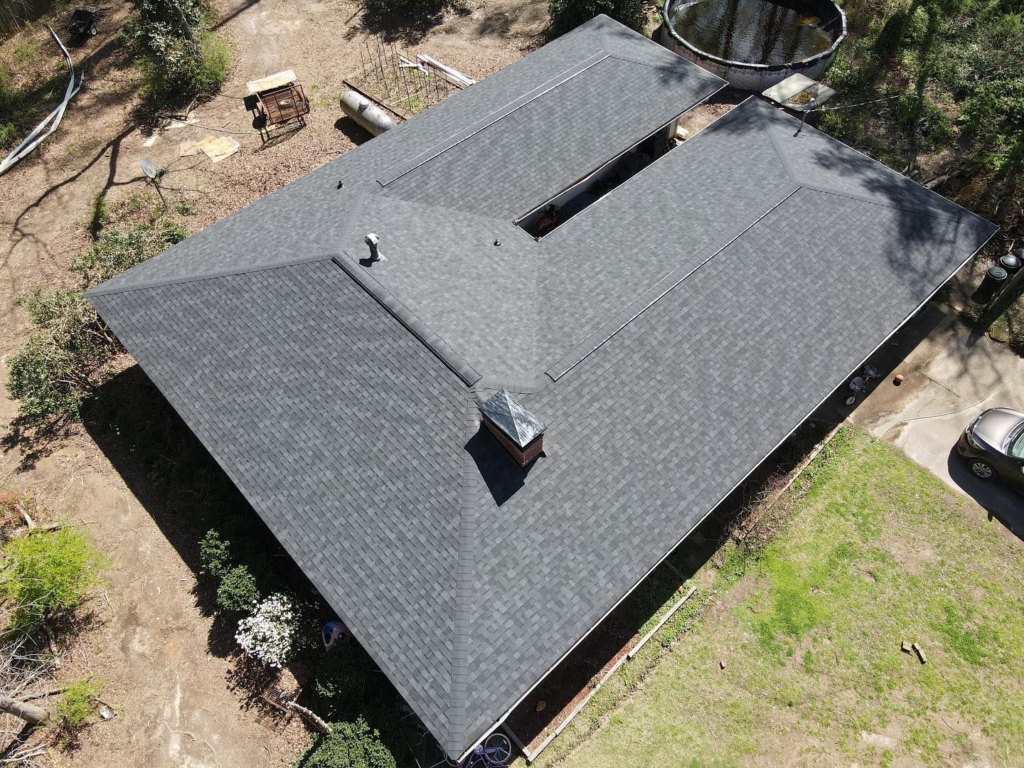 An aerial view of a house with a new roof.