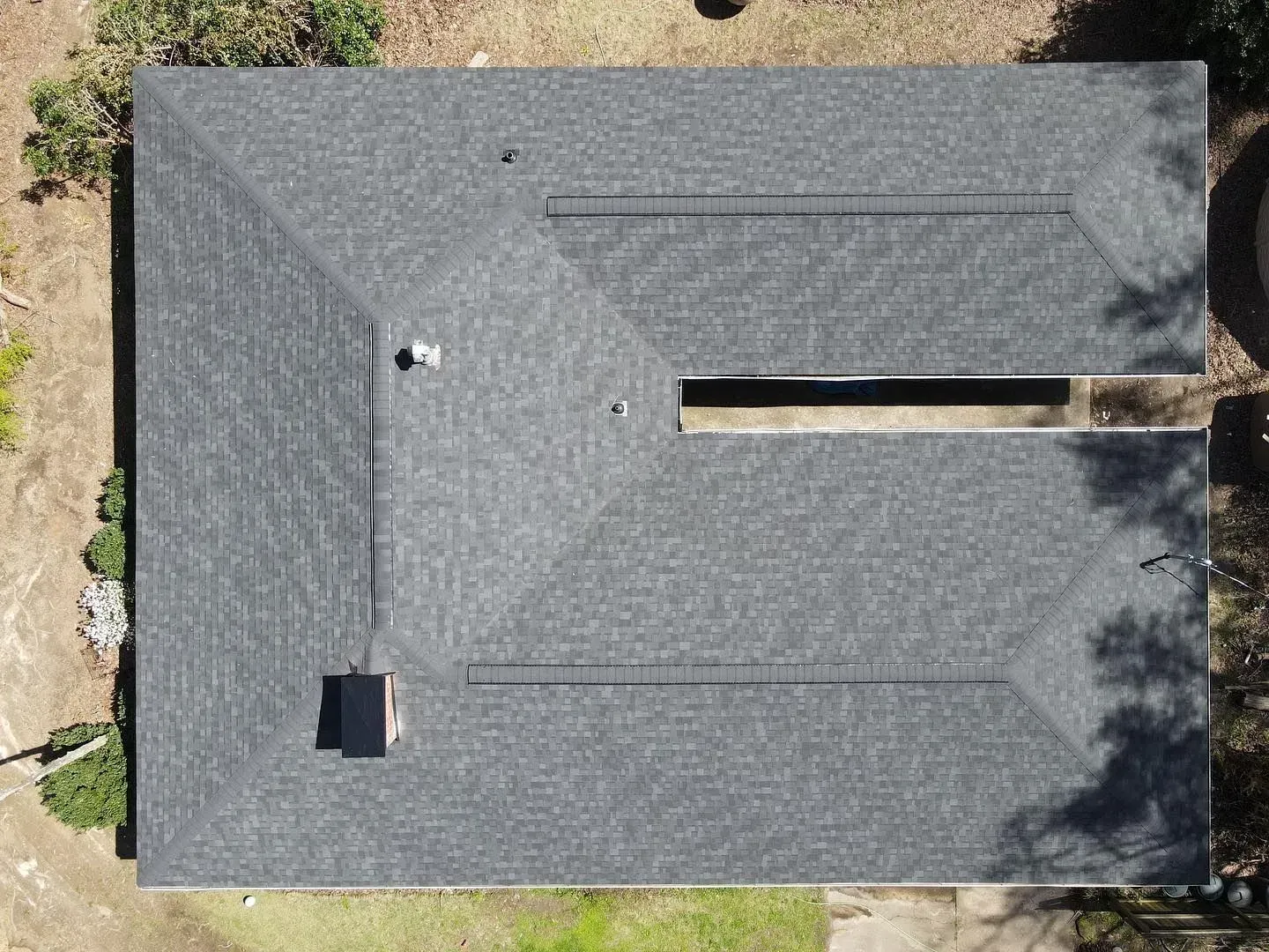 An aerial view of a house with a new roof.
