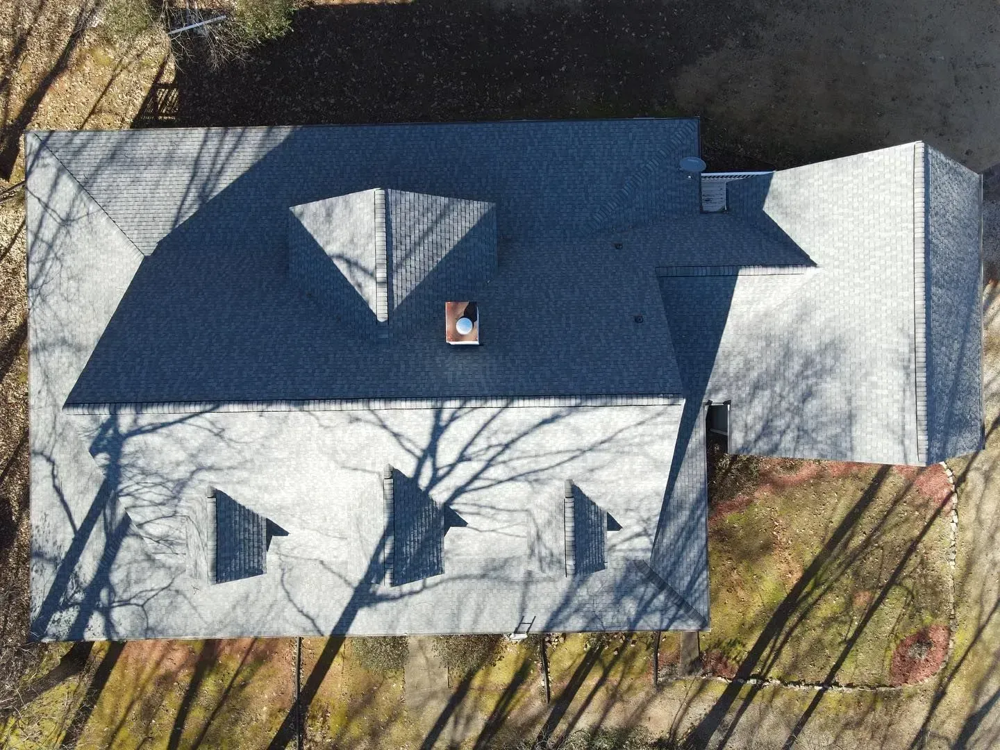 An aerial view of a house with a blue roof