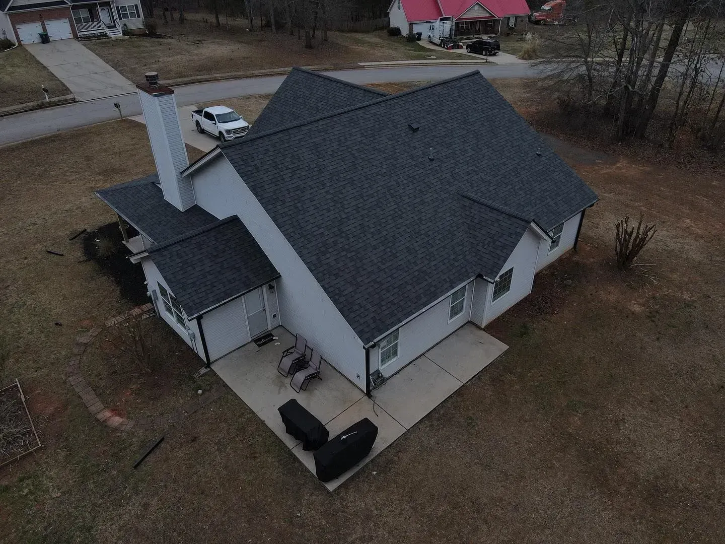 An aerial view of a house with a new roof.