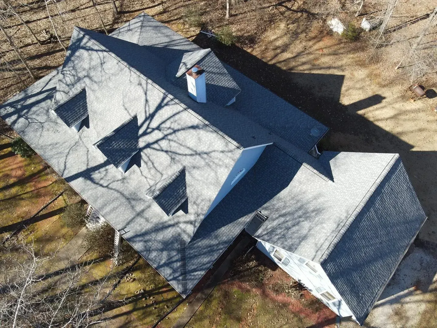 An aerial view of a house with a chimney on the roof