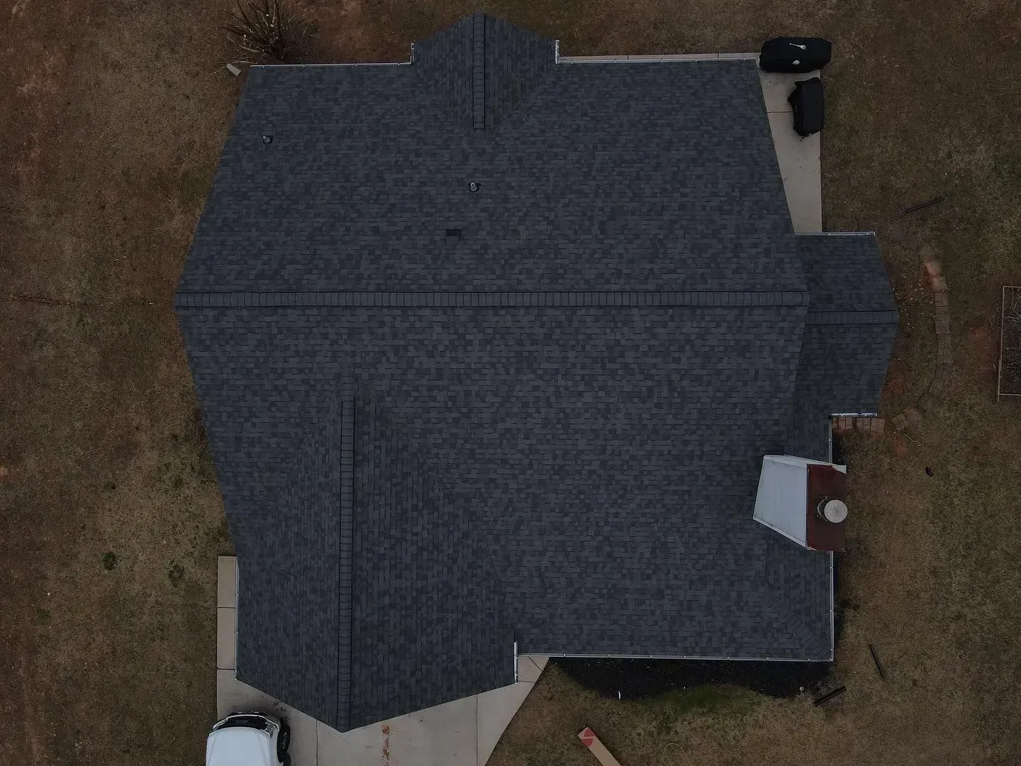 An aerial view of a house with a gray roof.