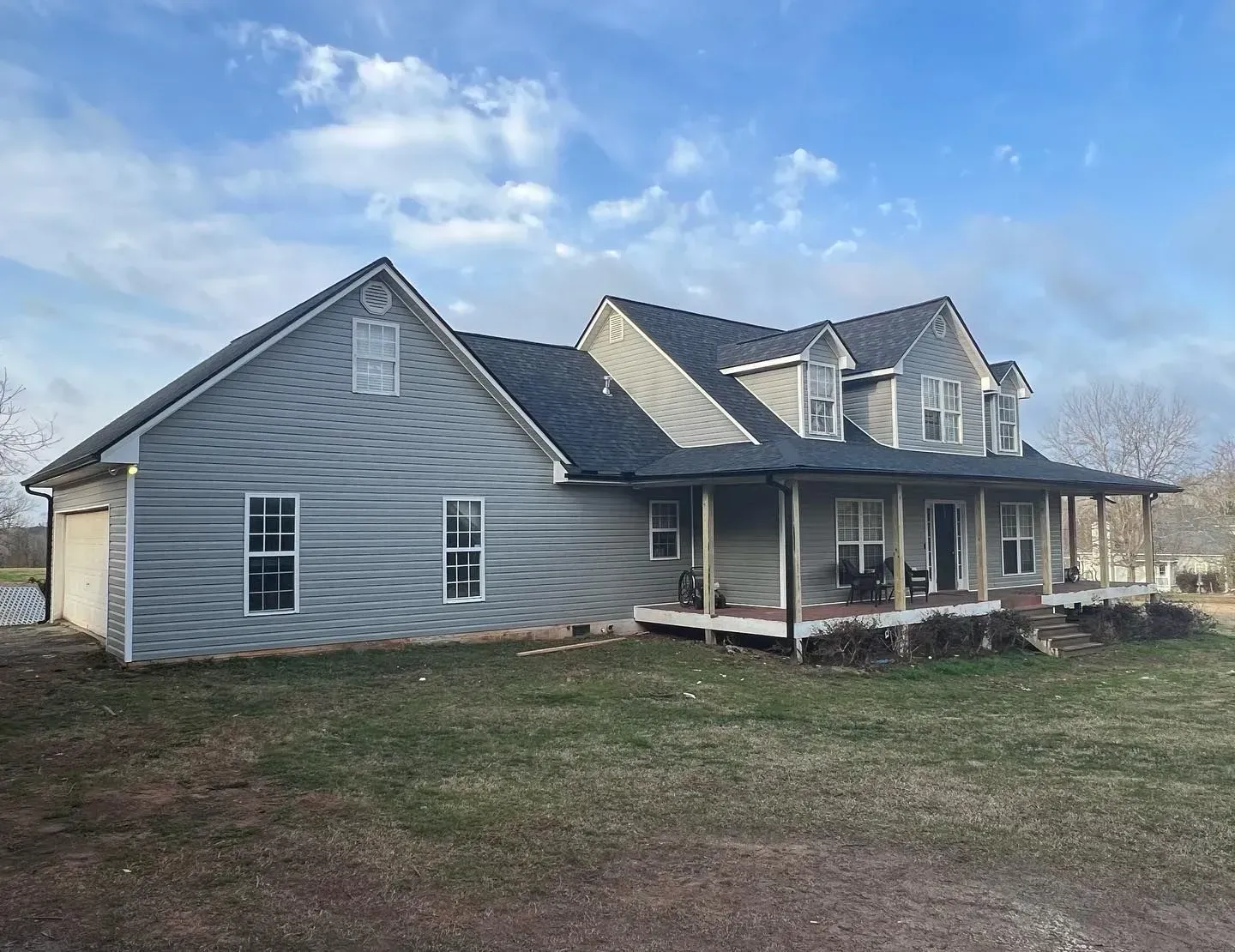 A large house with a porch and a garage is for sale.