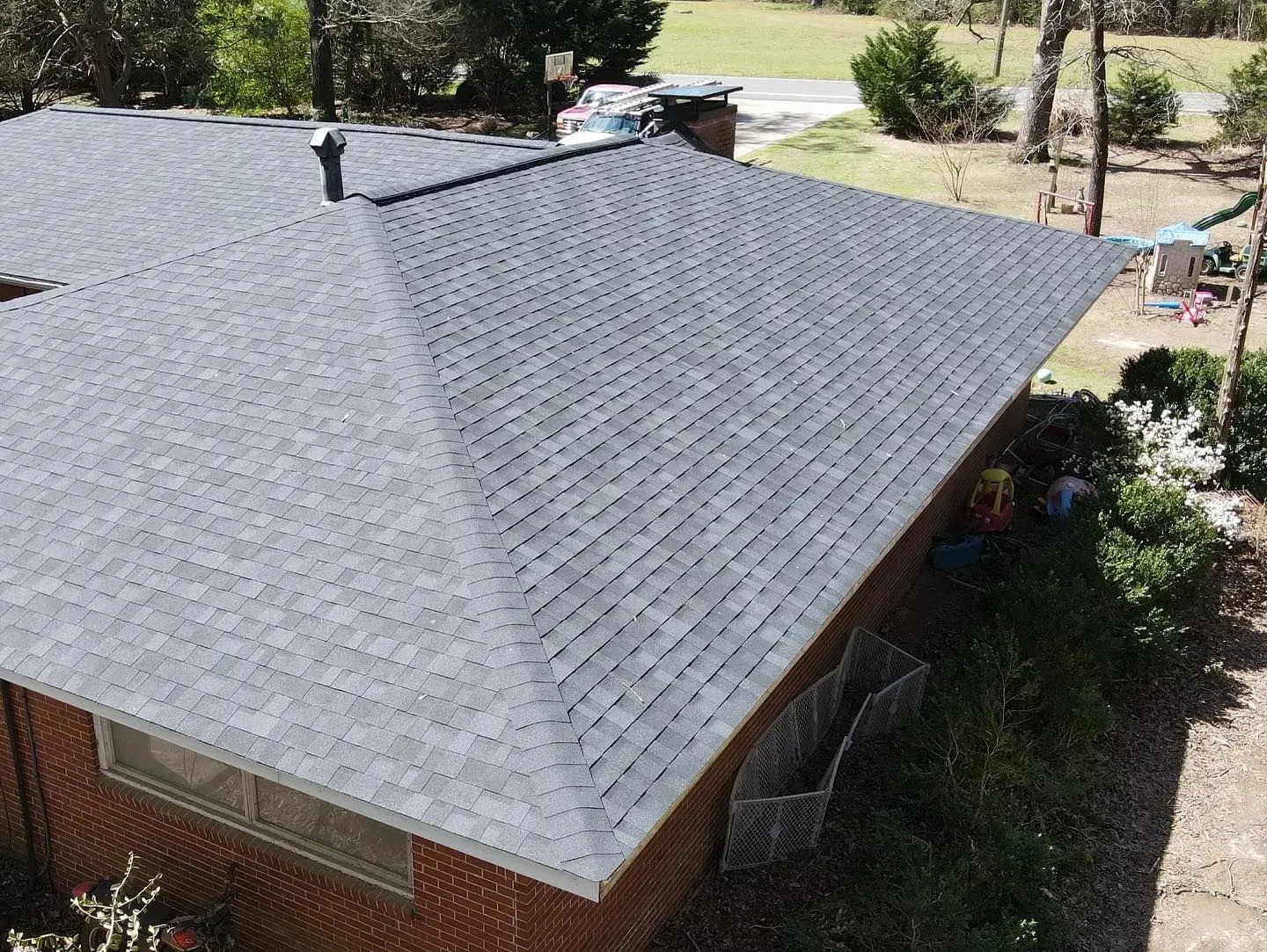 An aerial view of a house with a new roof.