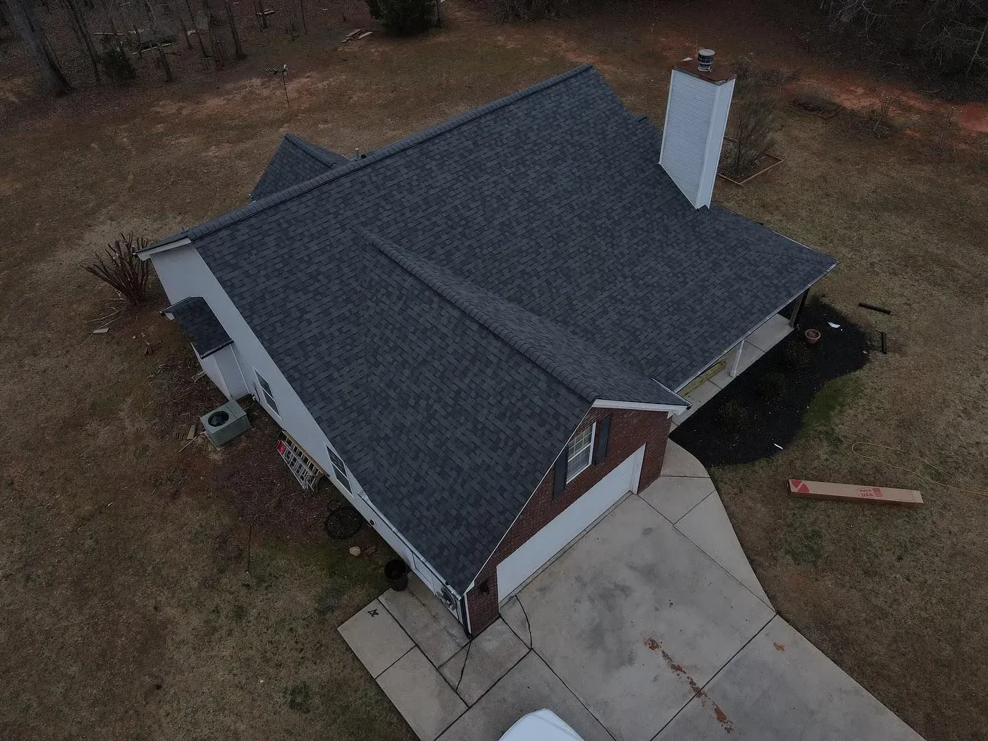 An aerial view of a house with a new roof.