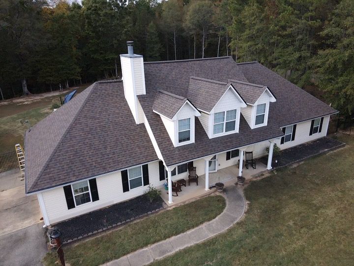An aerial view of a house with a covered porch