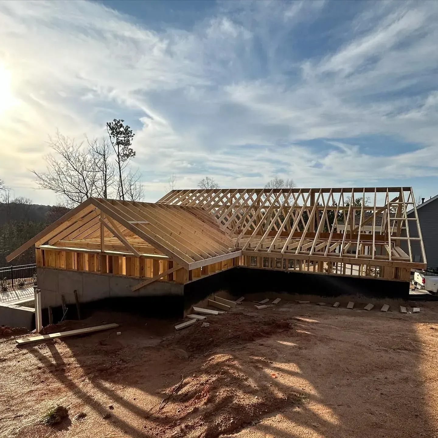 A house is being built on top of a dirt hill.