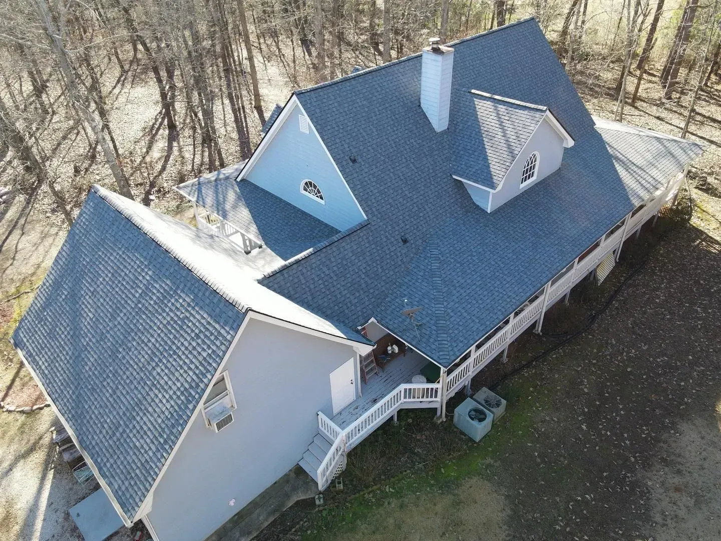 An aerial view of a house with a blue roof