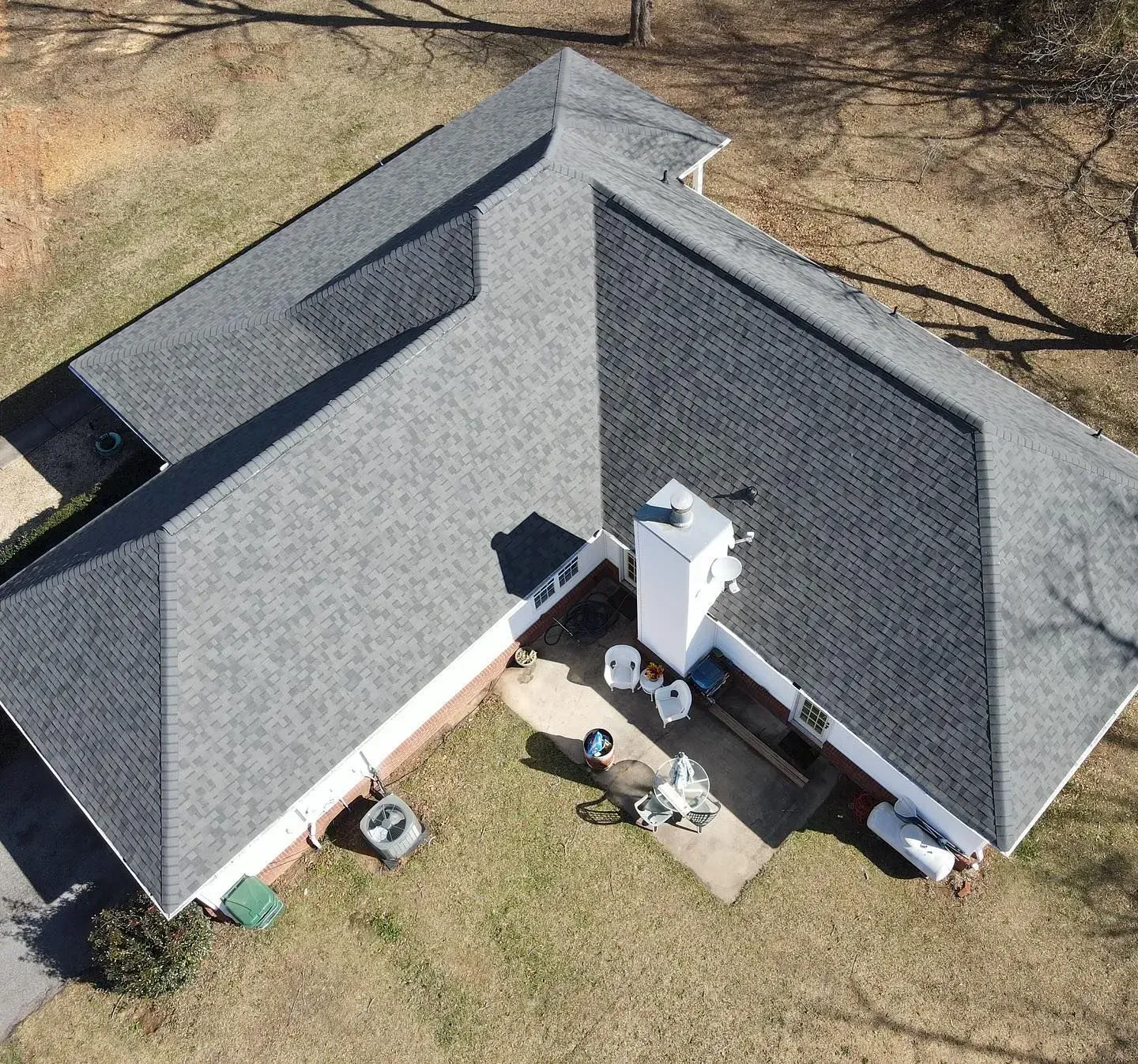 An aerial view of a house with a gray roof