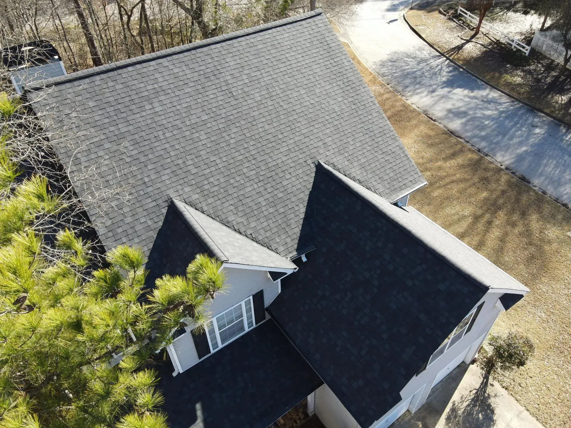 An aerial view of a house with a black roof