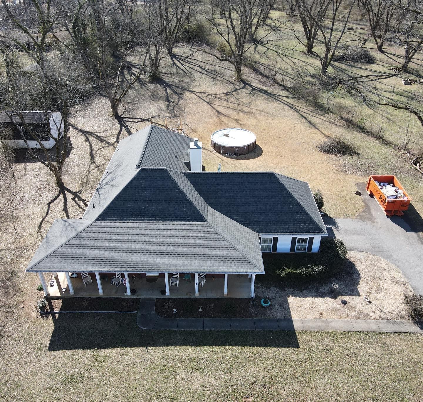 An aerial view of a house with solar panels on the roof.