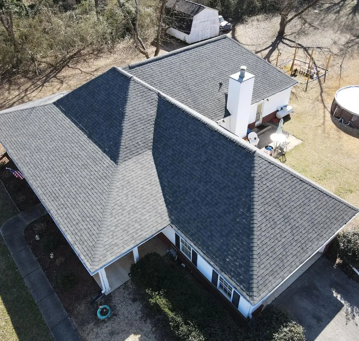 An aerial view of a house with a black roof