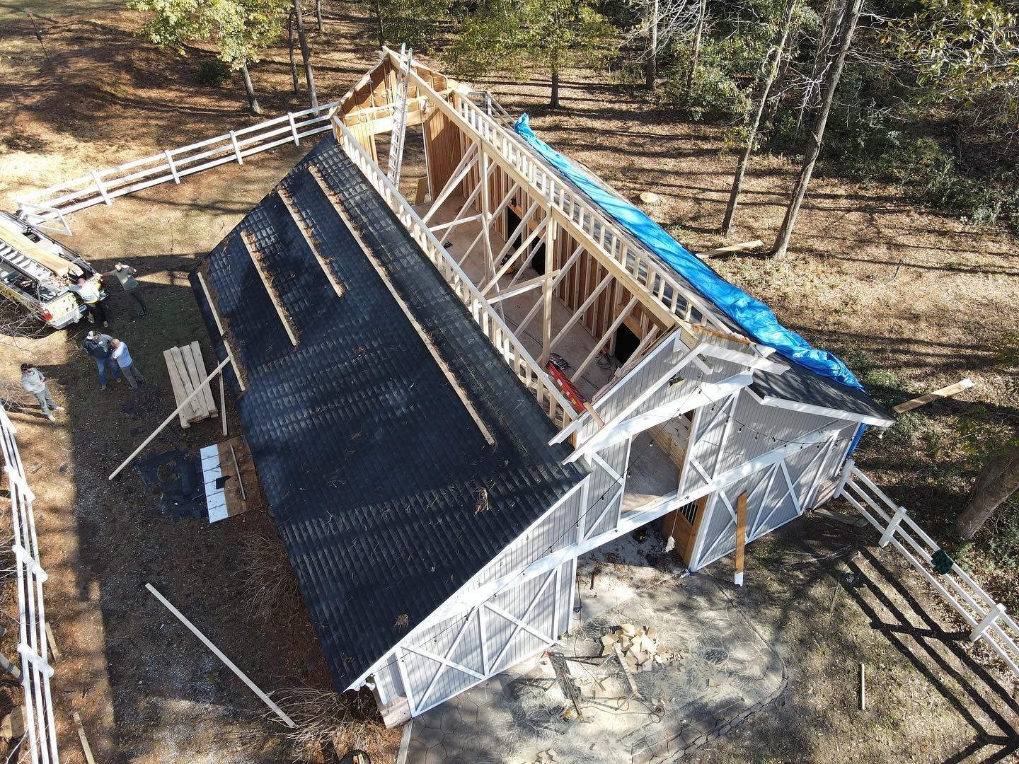 An aerial view of a house under construction in the woods.