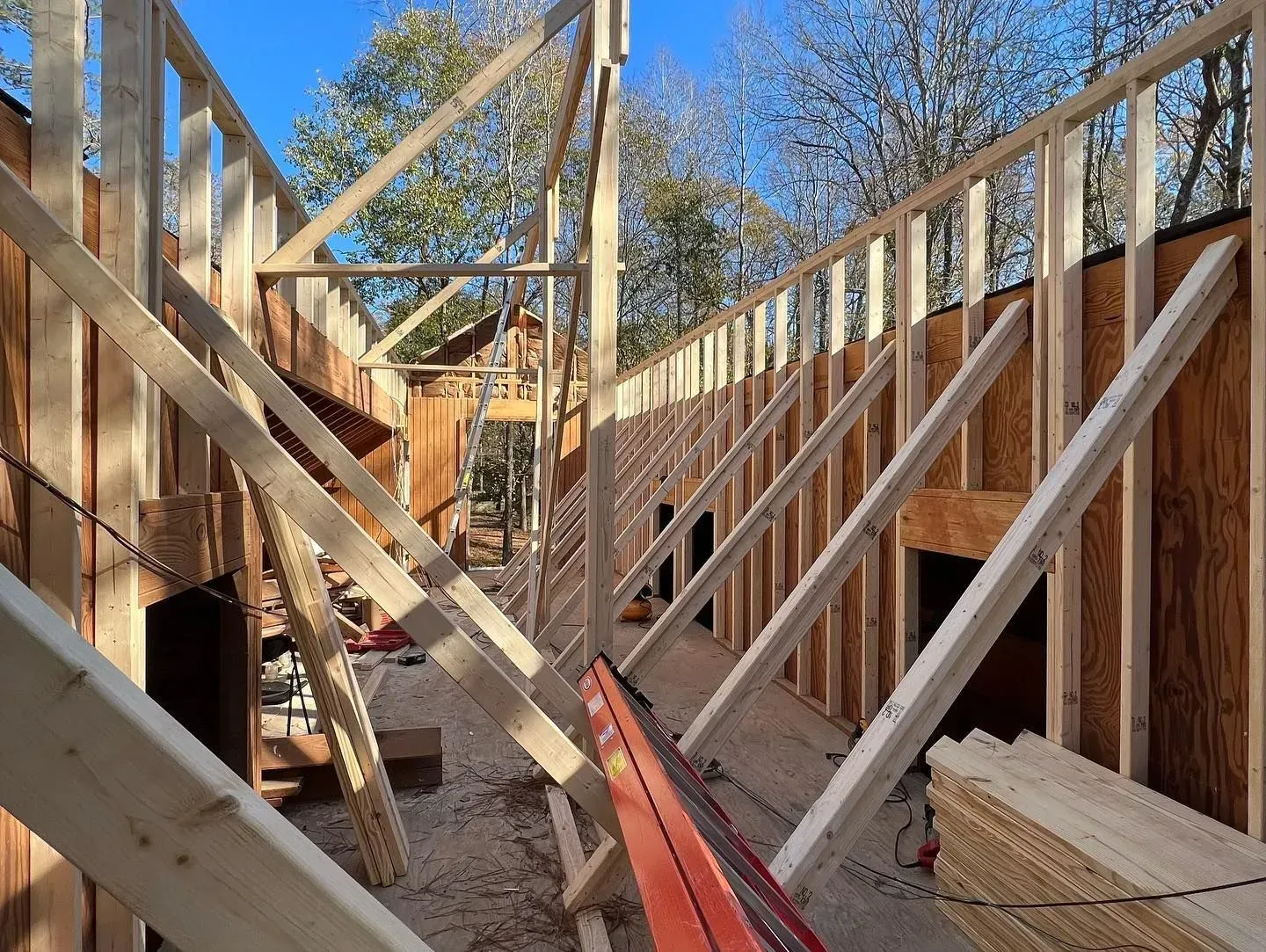 A house is being built with a lot of wooden beams.