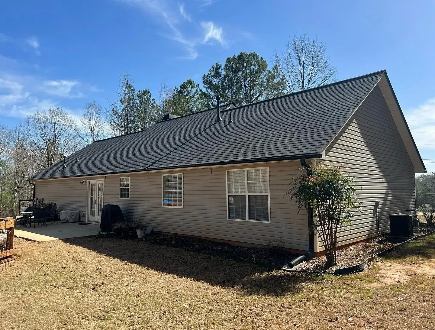 A house with a gray roof and a lot of windows