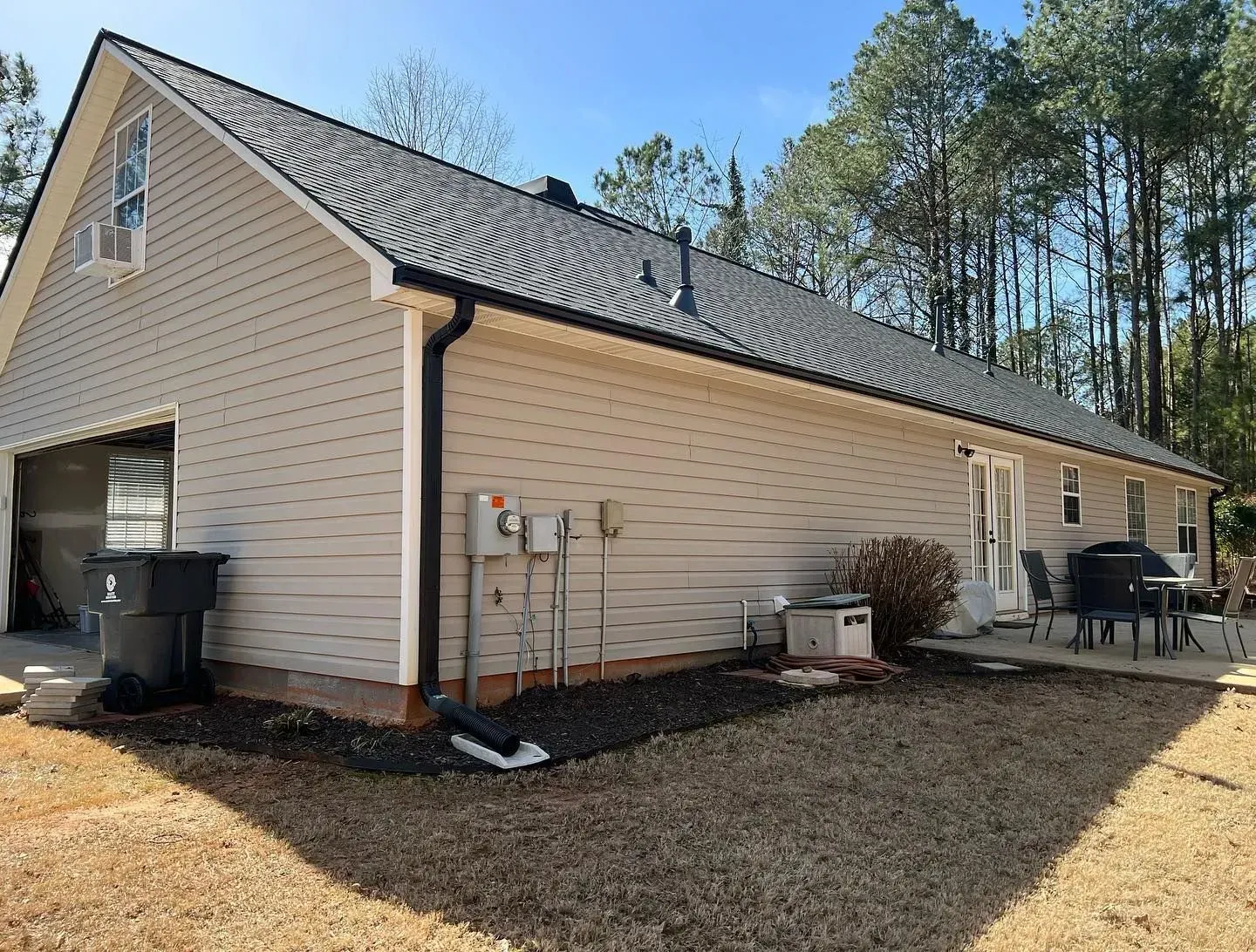 A house with a garage and a patio in the backyard