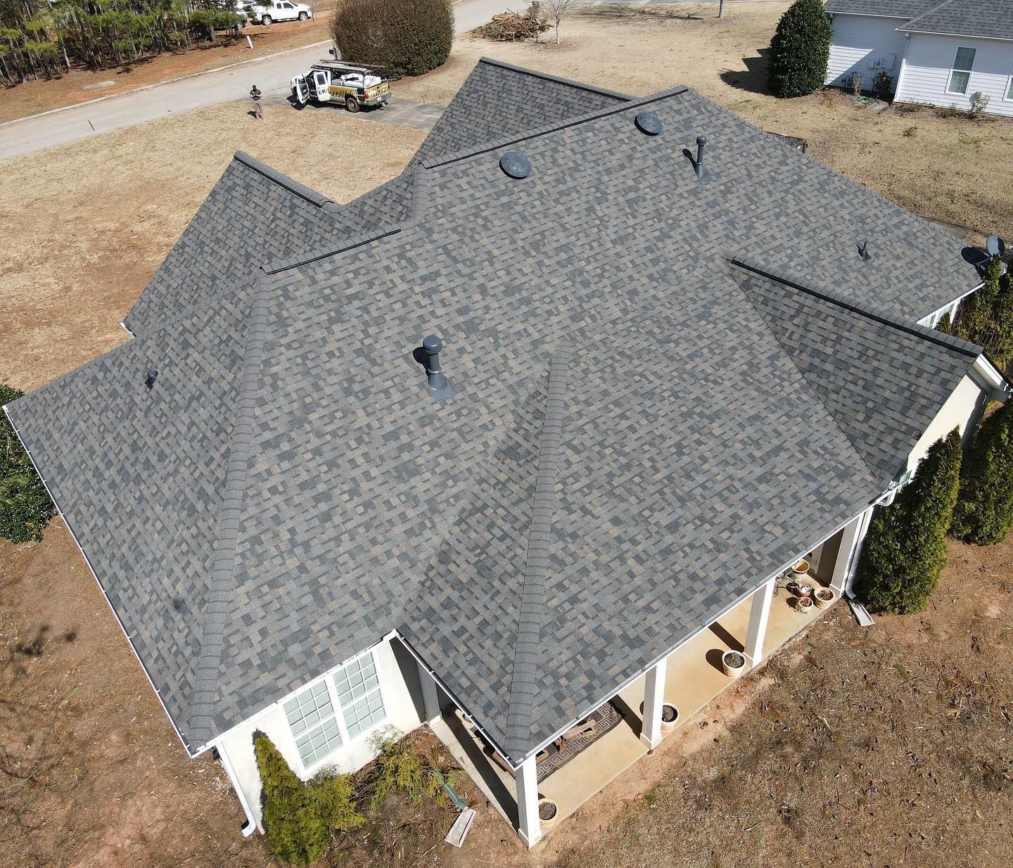 An aerial view of a house with a gray roof.
