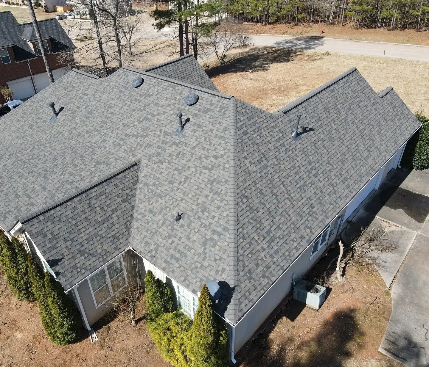 An aerial view of a house with a gray roof