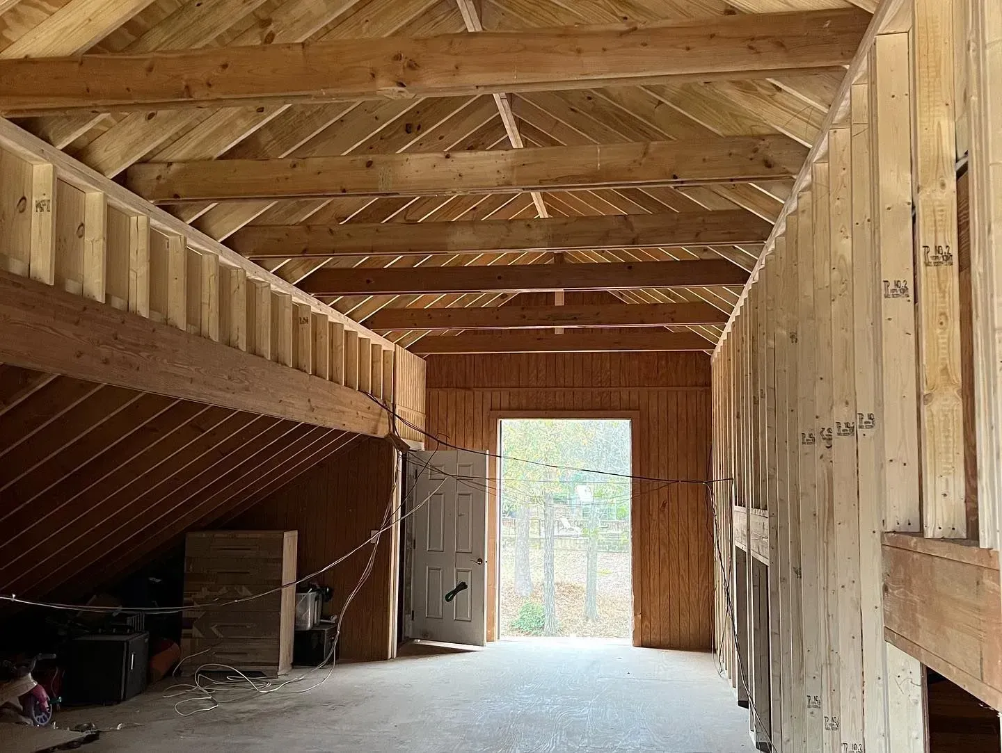 The inside of a building under construction with a door open.