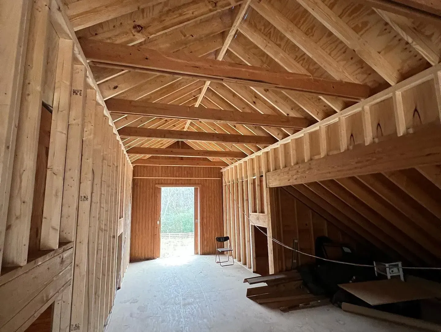 A room with a wooden ceiling and walls is being built.