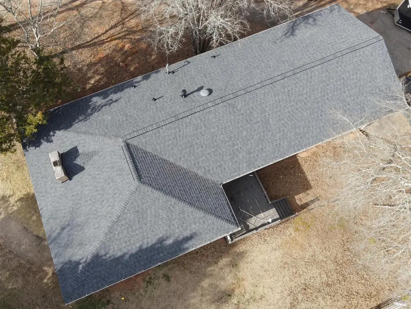 An aerial view of a house with a new roof.