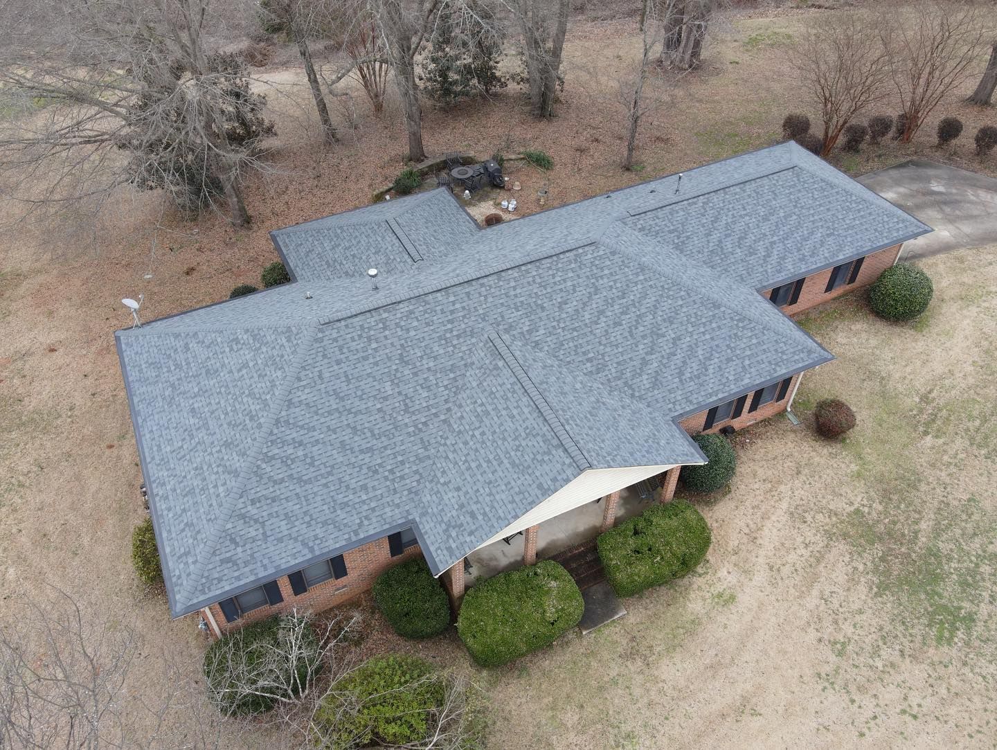 An aerial view of a house with a new roof.